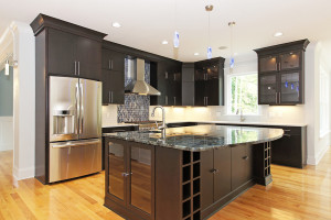 Kitchen with dark cabinets and stainless steel appliances