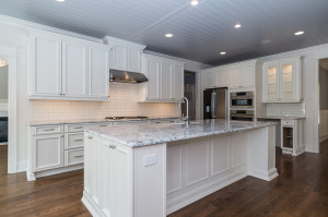 Kitchen with white cabinets and large center island
