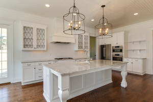 Large white kitchen with stainless steel appliances