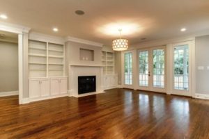 Bright and open family room with fireplace and custom shelving